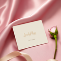 LuvlyPlay digital gift card on pink silk with a rose bud