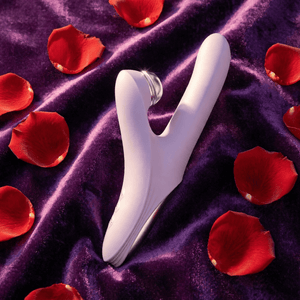 Linglong thrusting vibrator on purple velvet with rose petals - lifestyle shot
