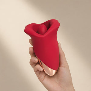 Sex Lips mouth vibrator held in one hand — palm-sized, about 13 cm long